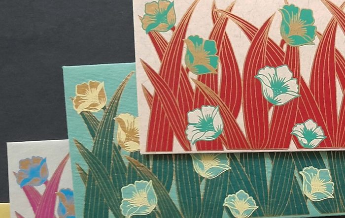 Embroidery-inspired floral linework on a Chimanlals card
